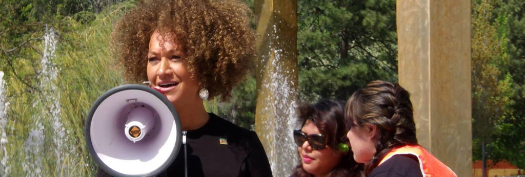 A photo of Rachel Dolezal speaking with a megaphone.