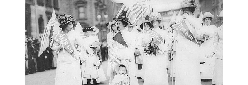 A photo of suffragettes dressed in white.