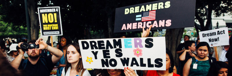 A photo from a Dreamers protest. People are carrying signs with messages like, "Dreamers Yes, No Walls" and "Dreamers = Americans."