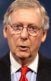 A photo of Mitch McConnell holding up some legislation