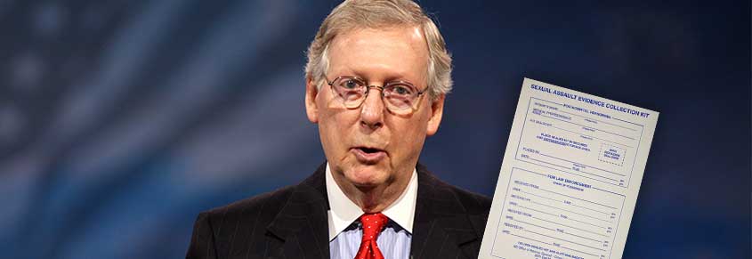 A photo of Mitch McConnell holding up some legislation
