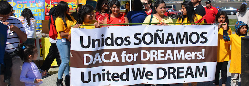 A photo of children protestors holding a sign that says "Unidos SONAMOS. DACA for DREAMers! United We DREAM."