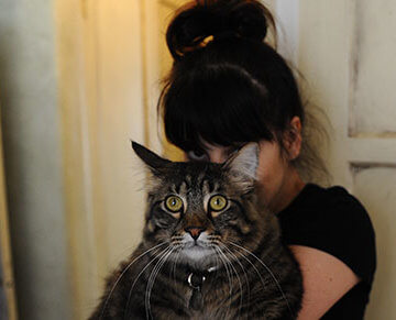 A photo of writer Carrie Borzillo holding her cat