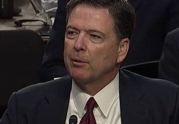 A photo of James Comey testifying at a hearing.
