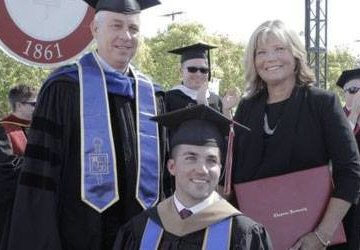 A photo of a mother and her son, who is in a wheelchair, at her son's graduation