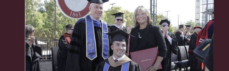 A photo of a mother and her son, who is in a wheelchair, at her son's graduation
