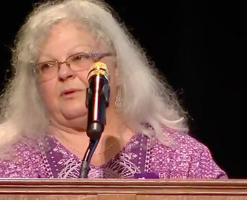 A photo of Susan Bro speaking at a podium