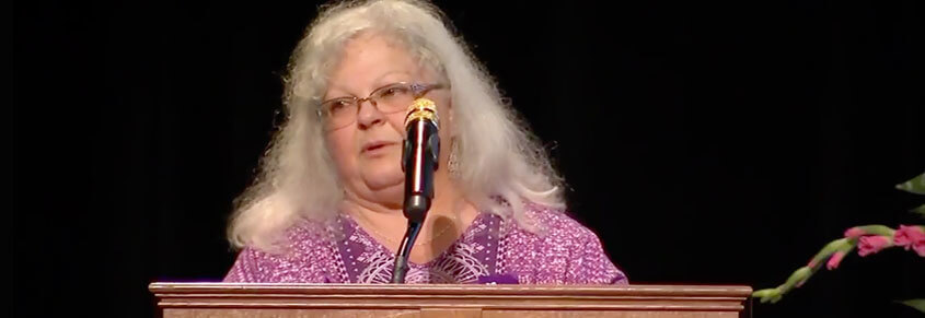 A photo of Susan Bro speaking at a podium