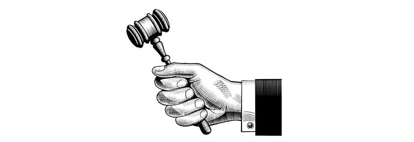 An illustration of a hand holding a gavel