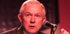 A photo of Jeff Sessions speaking into a microphone