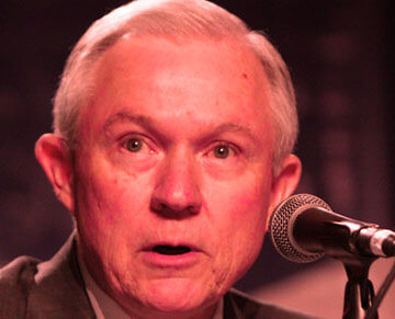 A photo of Jeff Sessions speaking into a microphone