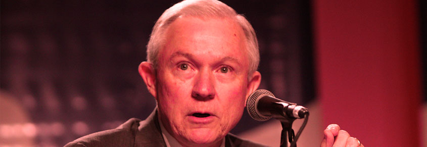 A photo of Jeff Sessions speaking into a microphone