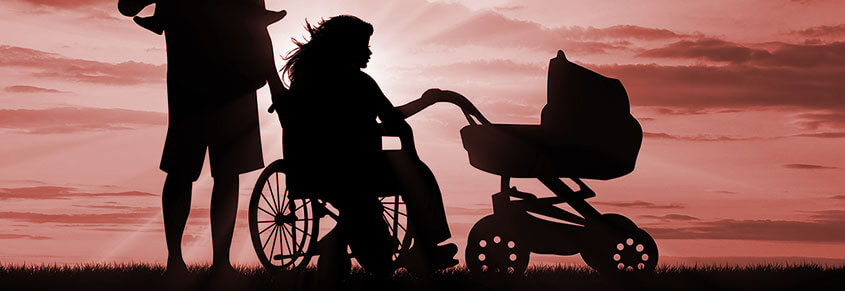 A photo of a person in a wheelchair touching a baby stroller