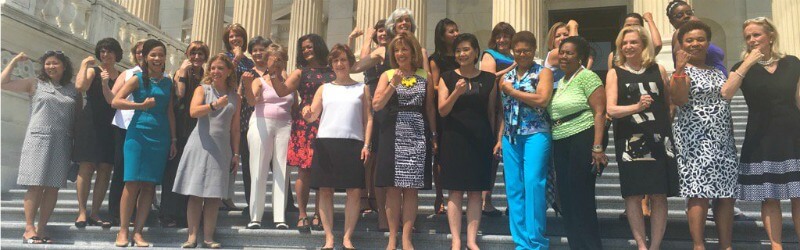 A photo of congresswomen wearing sleeveless outfits.