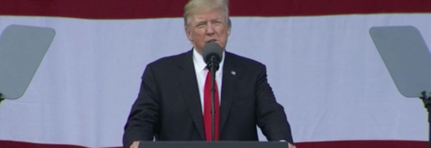 A photo of Donald Trump making a speech at an event.