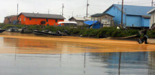 A photo of f Kivalina, Alaska, which shows flooding around houses