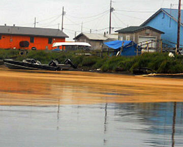 A photo of f Kivalina, Alaska, which shows flooding around houses