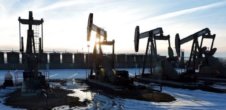 A photo of machines drilling for oil in a wintery area.