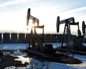 A photo of machines drilling for oil in a wintery area.
