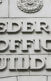 A photo of a Federal Office Building with a "Sorry, we're closed" sign on it.