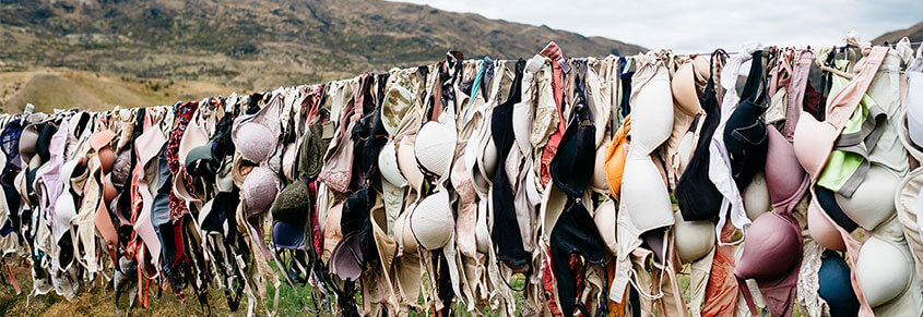 A photo of many bras airing out outside