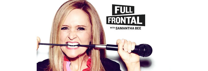 A promotional photo of Samantha Bee biting into a microphone cord for her show "Full Frontal with Samantha Bee"