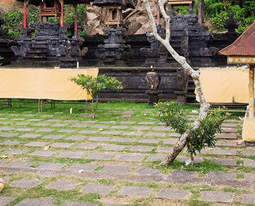 A photo of a woman meditating in a courtyard