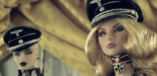A photo of two barbie dolls in solider-like outfits