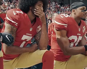 A photo of Colin Kaepernick kneeling with some teammates