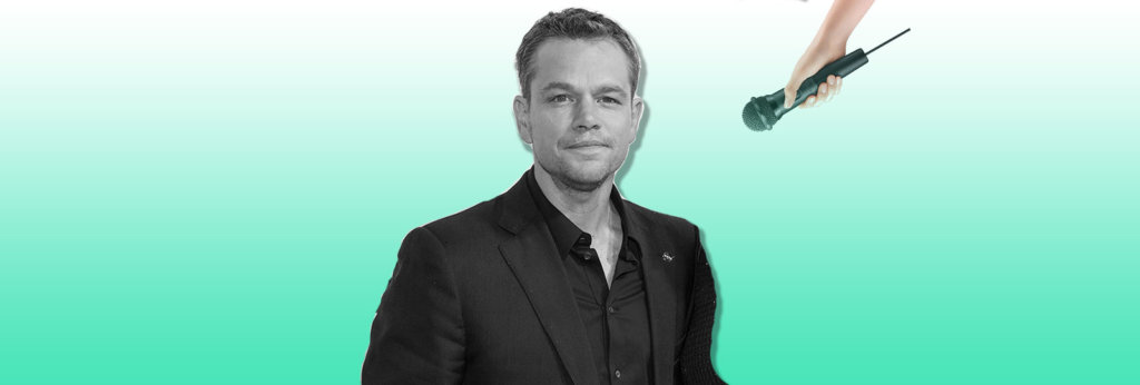 A photo of Matt Damon and someone holding a microphone up to him