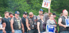 A photo of Trump supporters with signs like "Hillary For Clinton 2016"