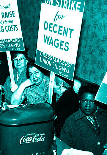 A photo from the earl 20th century of women holding pro-union signs, including one that says "On Strike for a decent Wage Raise to need rising Living Costs"