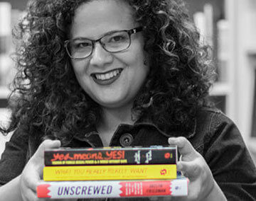 A photo of Jaclyn Friedman carrying books