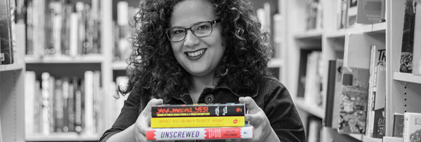 A photo of Jaclyn Friedman carrying books