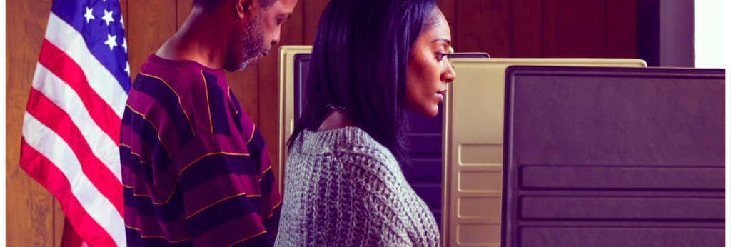 A photo of a Black woman and a Black man at a voting location