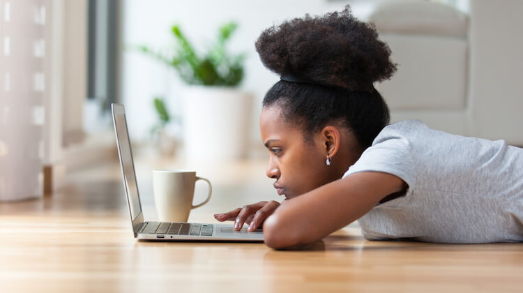 A photo of a Black woman using her computer