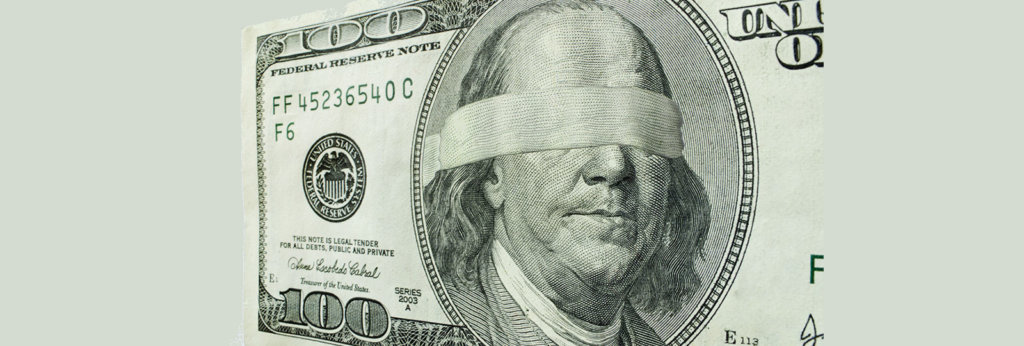 An hundred dollar bill with a blind fold over Benjamin Franklin's eyes