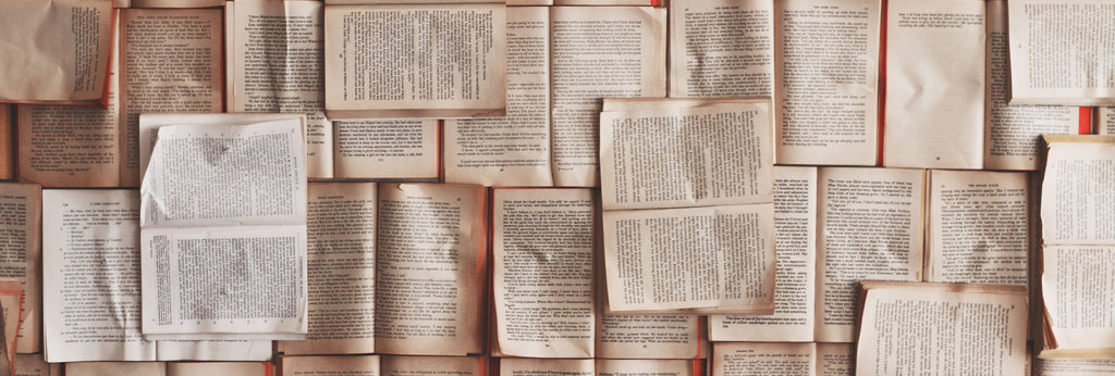 A photo of books laid out over each other