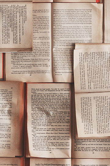 A photo of books laid out over each other
