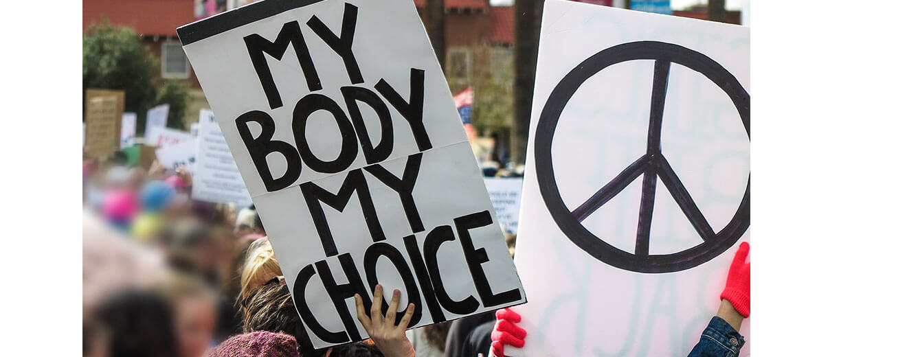 A photo of a protest, a visible sign says, "My Body My Choice."