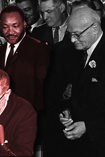 A photo of MLK, Lyndon Johnson and other politicians surrounding the Kerner Report