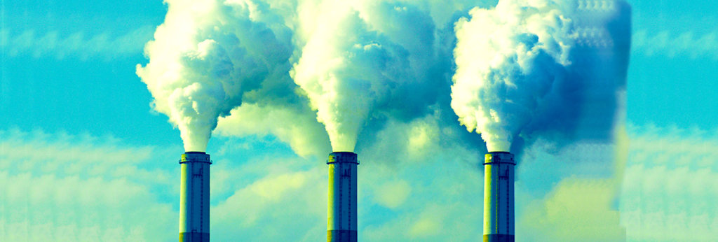 A photo of smoke coming out of factory chimneys