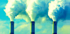 A photo of smoke coming out of factory chimneys