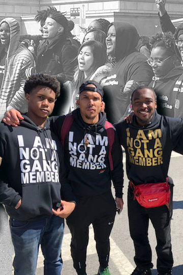 A photo from a protest with Black youth at front, with one holding a sign that says "We hope to see you at the next Black Lives Matter march.