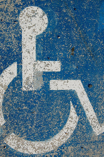 A photo of a fading handicap sign