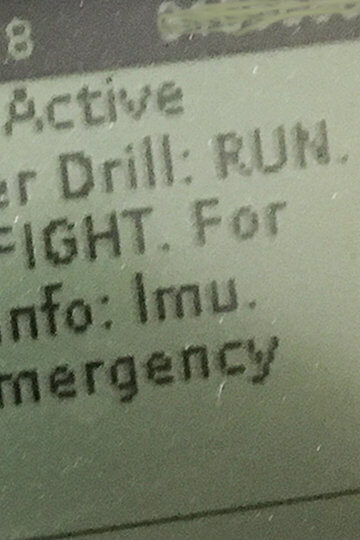 A message on a machine that says, "Drill – Active. Shooter Drill: Run. Hide. Fight. For more info: Imu.edu/emergency