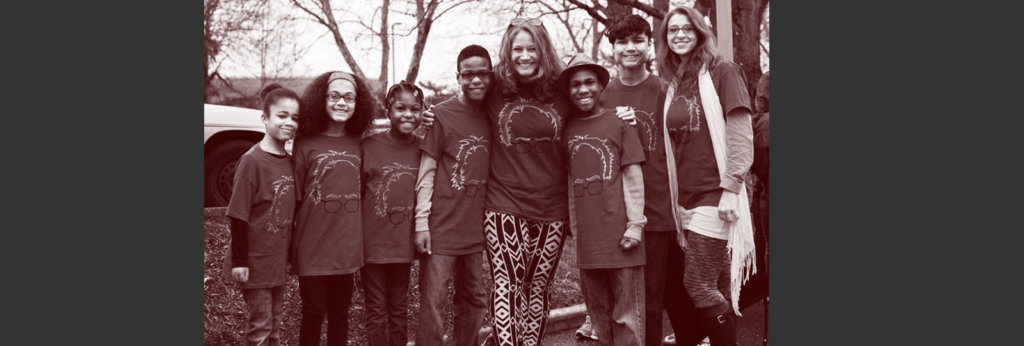 A photo of the Hart parents, two white women, and their six Black adopted children.