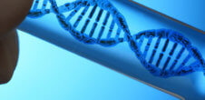 A person holding a sample of DNA inside of a vial.