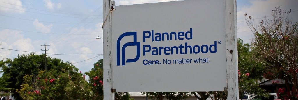 A photo of an entrance sign that says "Planned Parenthood. Care. No Matter what."