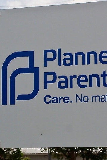 A photo of an entrance sign that says "Planned Parenthood. Care. No Matter what."